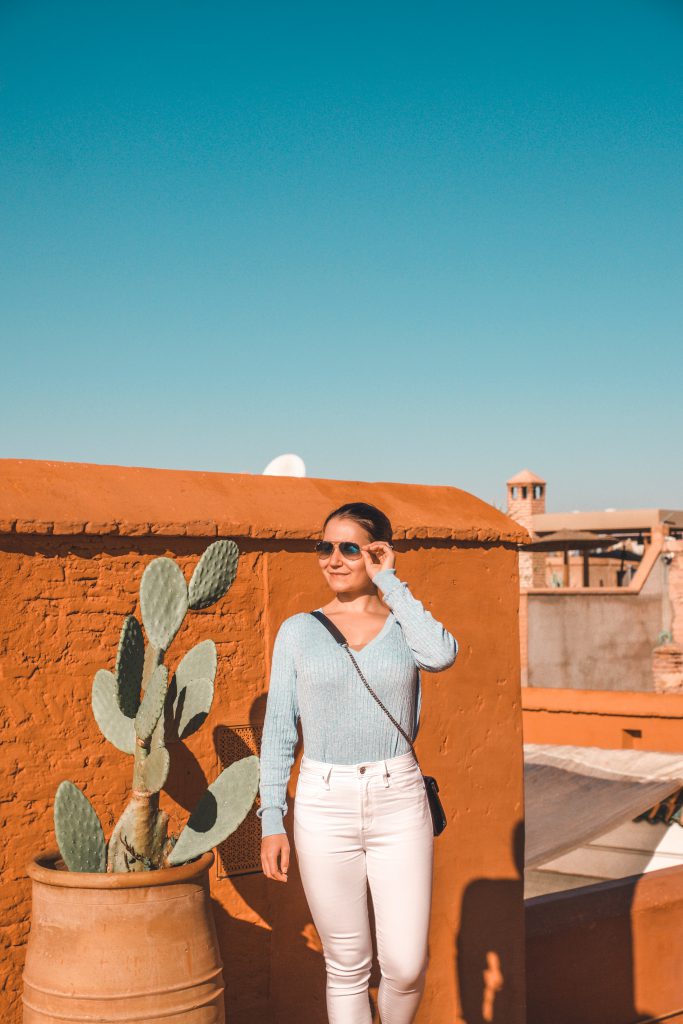 Standing on a rooftop in a Moroccan Riad, enjoying the sun on a sunny day in Marrakech.