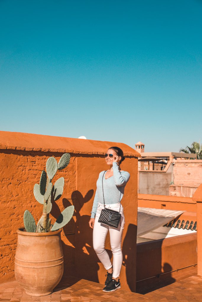 Standing on a rooftop in a Moroccan Riad, enjoying the sun on a sunny day in Marrakech.