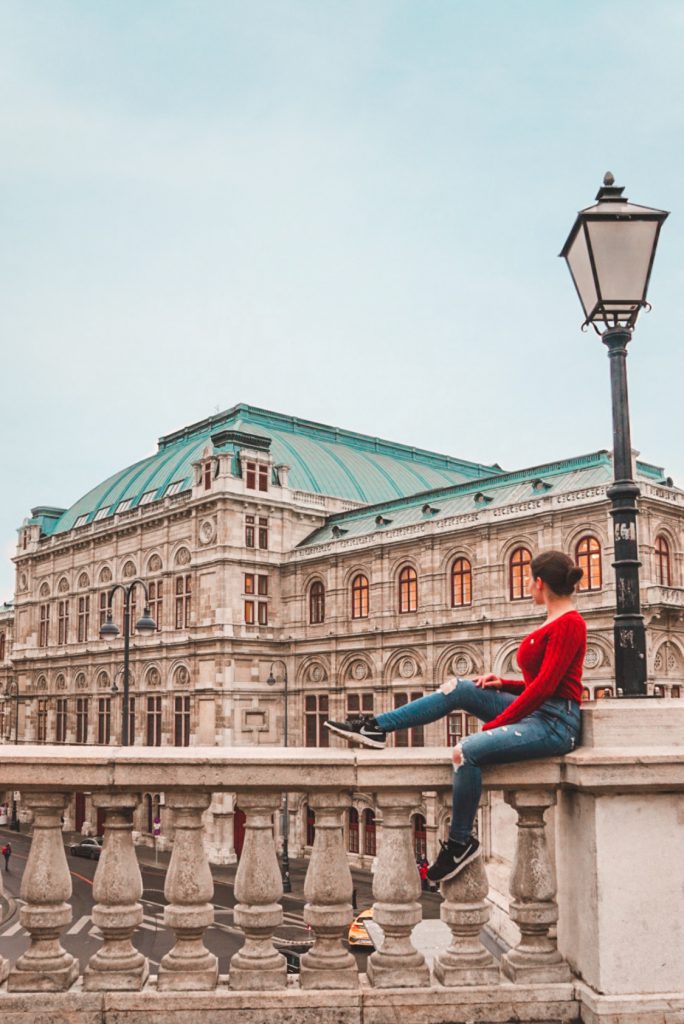 Girl sitting in front of the Vienna State Opera | Best Photo Spots in Vienna