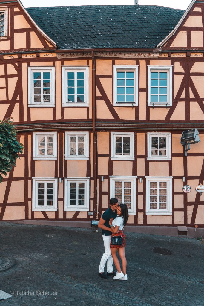 Travel Couple from Germany posing in front of a half-timbered house in Linz am Rhein