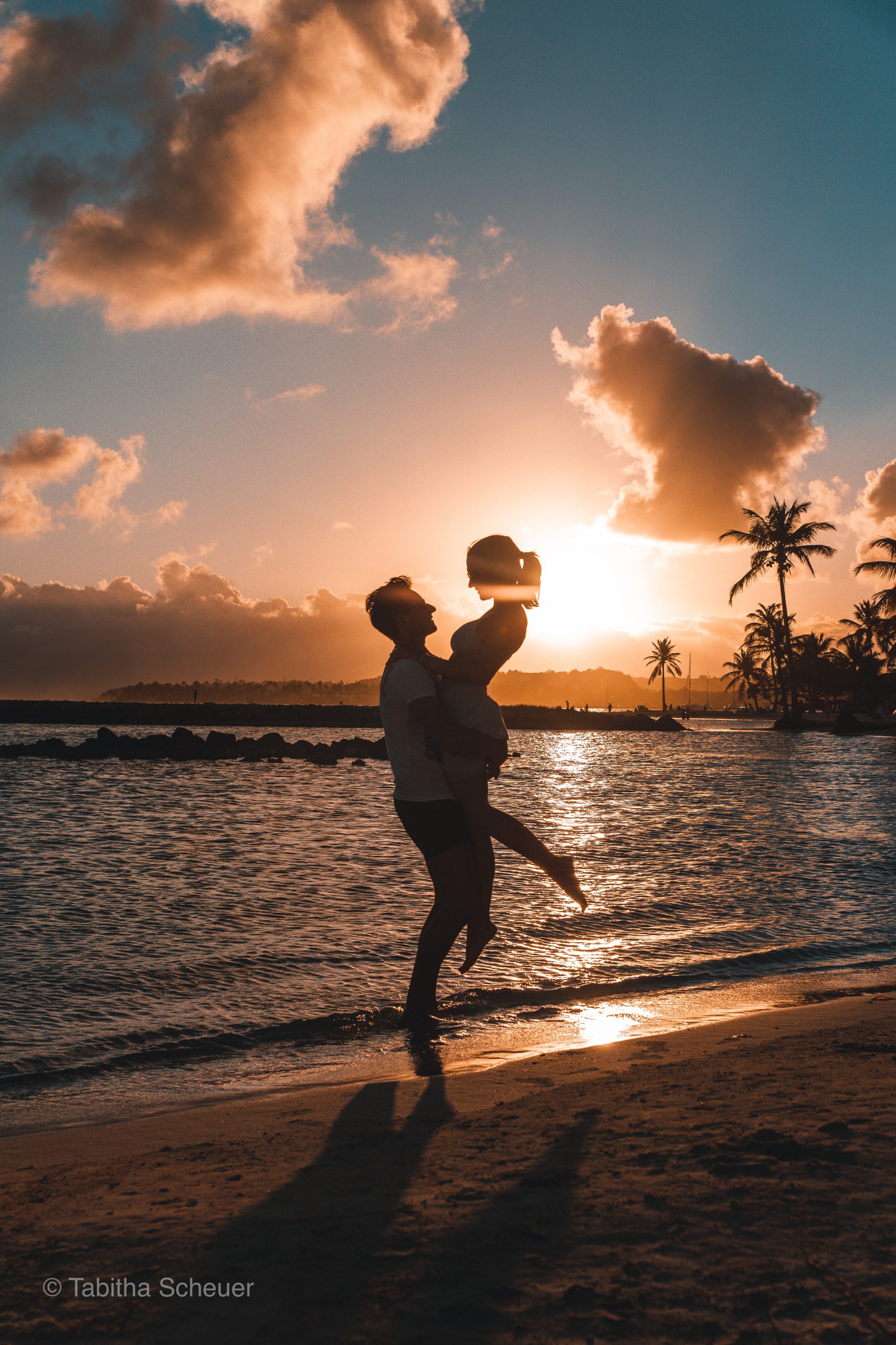 The silhouette of a romantic couple is jumping at sunset. Having a big  heart shape around there. Stock Photo | Adobe Stock