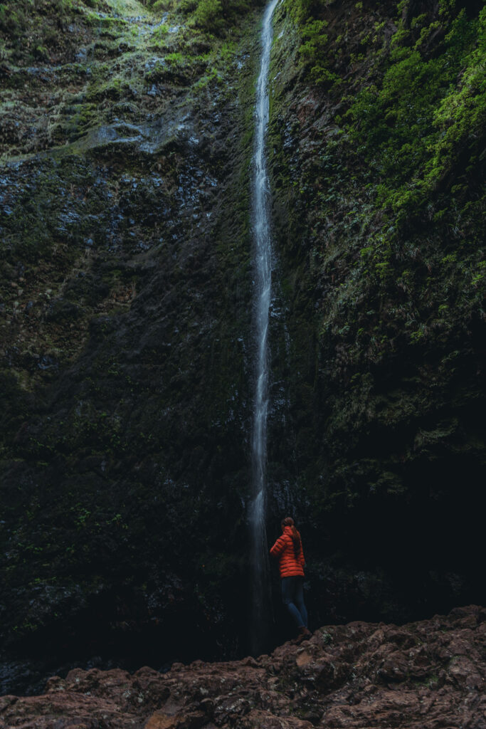 Madeira PR9 hiking trail - girl standing in front of the waterfall 